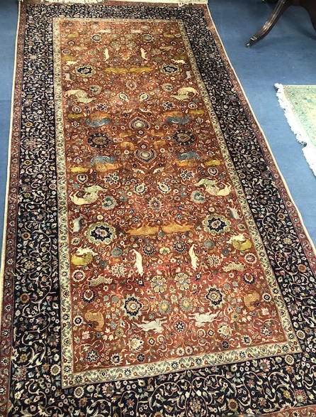 An Indian red and blue ground carpet 319 x 153cm